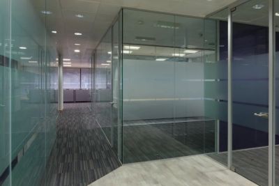 Open plan office with glass partitions creating meeting rooms in Medway commercial building by TJW D