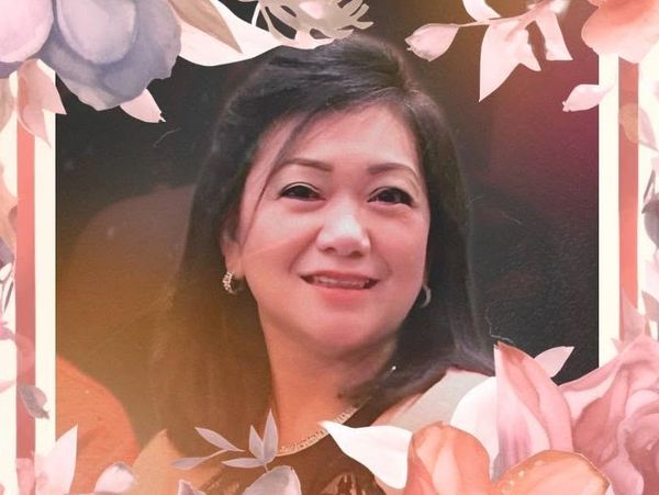 Portrait of a smiling woman with floral border.