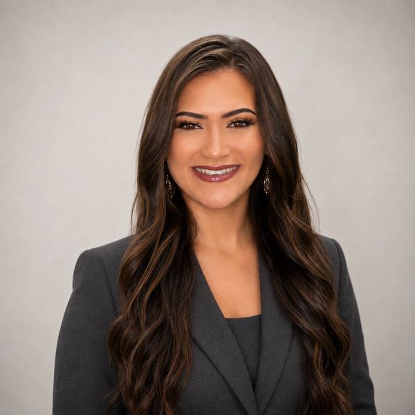 Professional woman smiling in business attire.