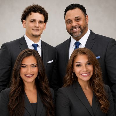 Group of four professionals posing for a photo.