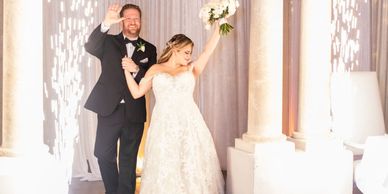 A couple making their grand entrance with sparklers on the sides.