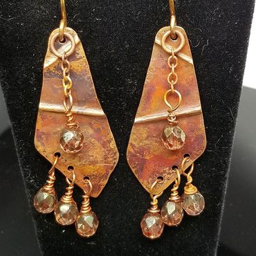 "Do I have Creases Yet" earrings. Hand pounded copper with green beads. $55.00 USA Dollars