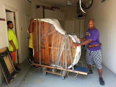 Legacy Moving Piano Movers relocating a grand piano from one house to another house in Dallas, Texas