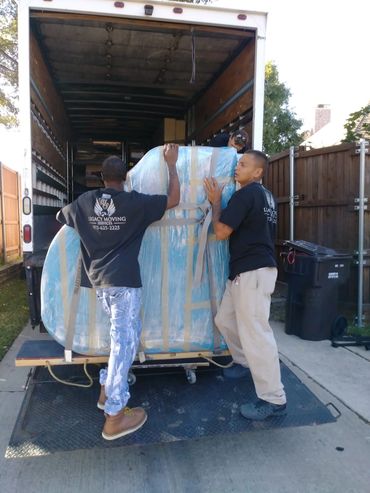 Legacy Moving Piano Movers loading a small baby grand piano to go to Plano, Texas