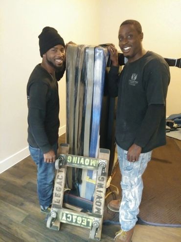 Operation's manager Willie (on left) and Rico taking a picture after moving a baby grand into a home