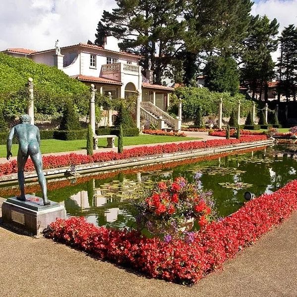 The main garden at Compton Acres with pond and statues.,