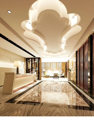 Elegant lobby with intricate ceiling design and polished marble floors.