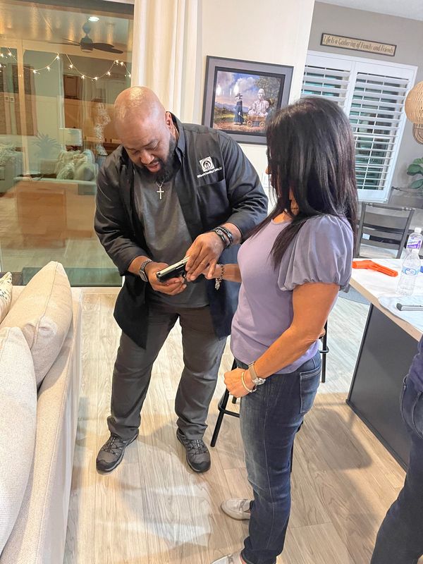 Two people looking at a phone indoors.