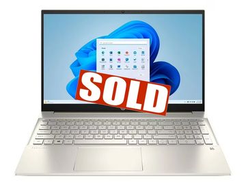 A gold laptop with a 'SOLD' sign on the screen.