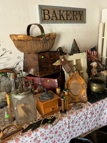 Vintage kitchen and decorative items displayed under a 'BAKERY' sign.