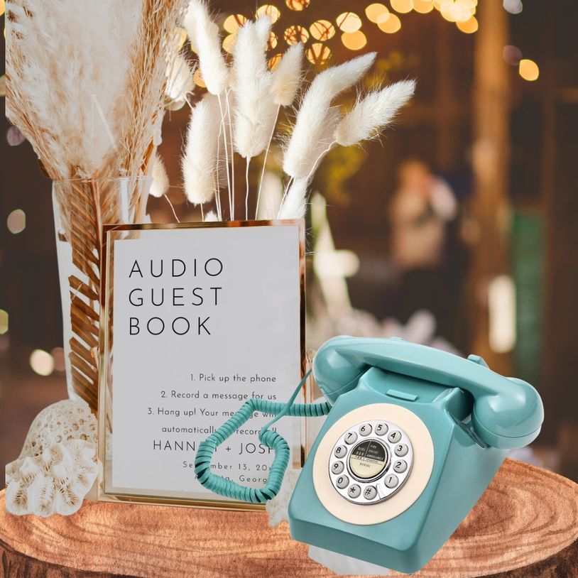 Vintage phone and sign for an audio guest book on a wooden table with decorative plants.