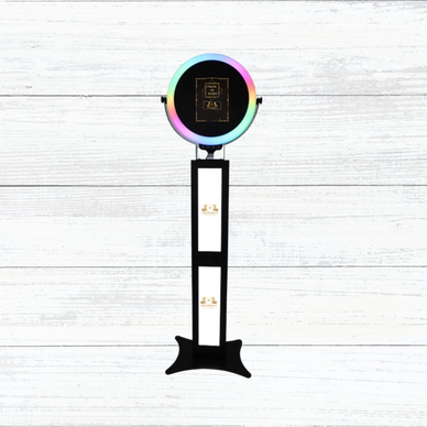 Modern photo booth with colorful ring light and touch screen.