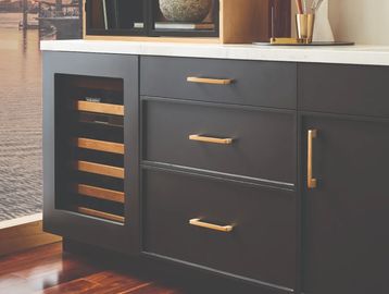 Copper cabinet pulls on charcoal minimalist cabinets