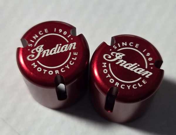 Two red metallic caps with 'Indian Motorcycle Since 1901' logo.