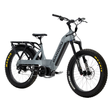 A modern gray electric mountain bike with thick tires and rear rack.