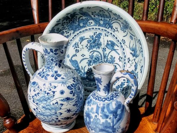 A large Delft bowl and two wine jugs - all early