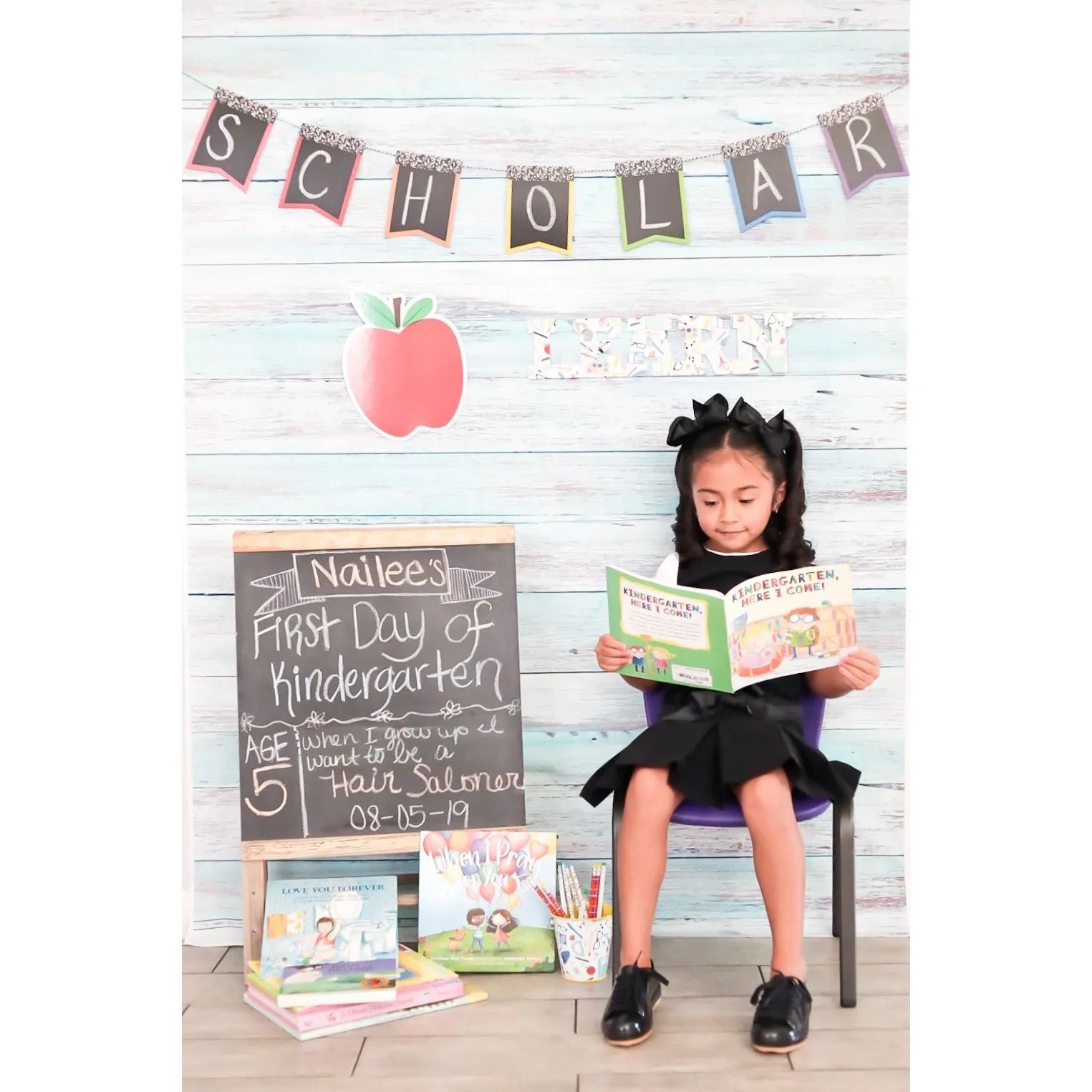 Kindergarten girl reading best-selling book Kindergarten, Here I Come! by author DJ Steinberg