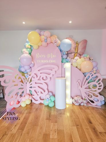 Butterfly and pastel themed balloon display.
