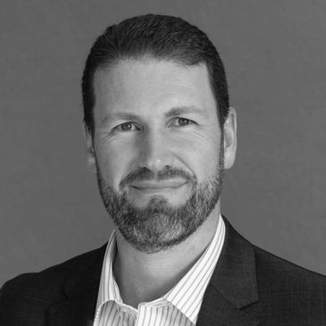 Black and white portrait of a man in business attire.