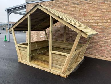 WUBI - Wood U Believe It Ltd - Outdoor Learning Shelter with sloped sides and bench seating