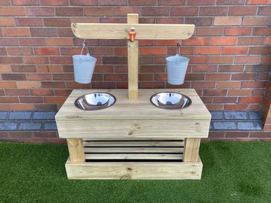 Weighing and measuring station with balance scales over, outdoor wooden educational resources.