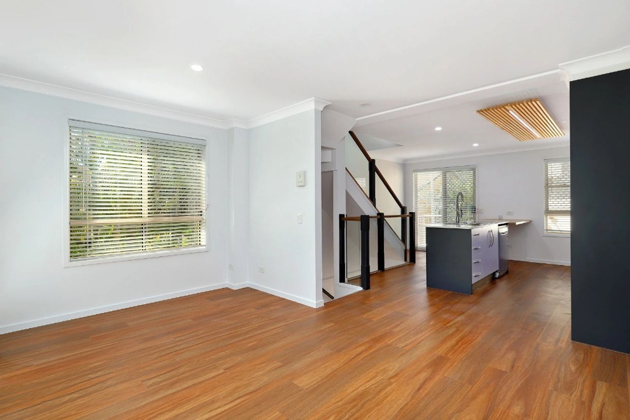 6.5mm Hybrid flooring in colour Spotted gum laid in a lounge and kitchen area