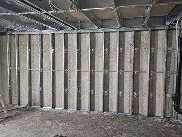 Metal framework for drywall installation on concrete wall.