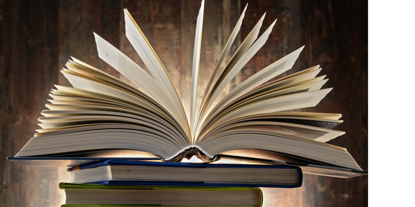 stack of closed books with one book on top open with pages flared out in an arc