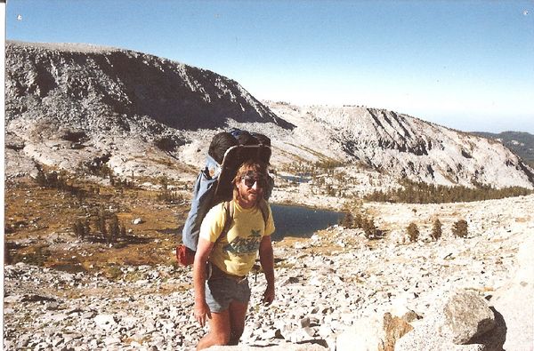 Clarke hiking in the Sierra Nevada mountains with large rucksack, rugged landcape, white boulders