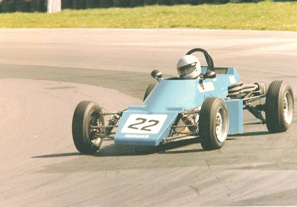 AFN Clarke on race track in blue race car number 22 on the front