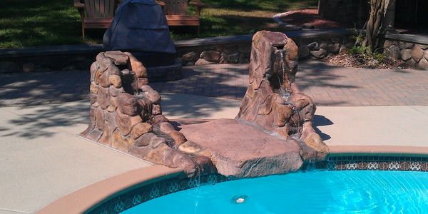Water fountain and diving rock. Made from carved and color-stained concrete.