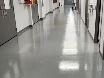 Colored epoxy with urethane top coat. Durable, low-maintenance, and beautiful.