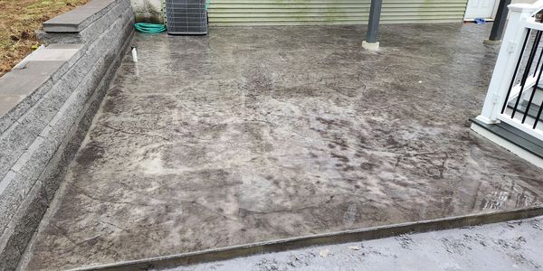 Allan Block retaining wall with seamless stamped concrete patio.