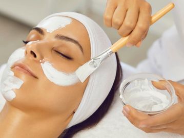 Woman receiving facial by esthetician