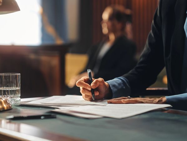 A lawyer in court writing down on documents