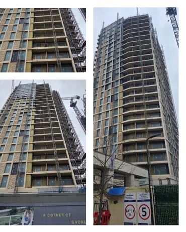 High-rise building under construction with cranes and scaffolding.