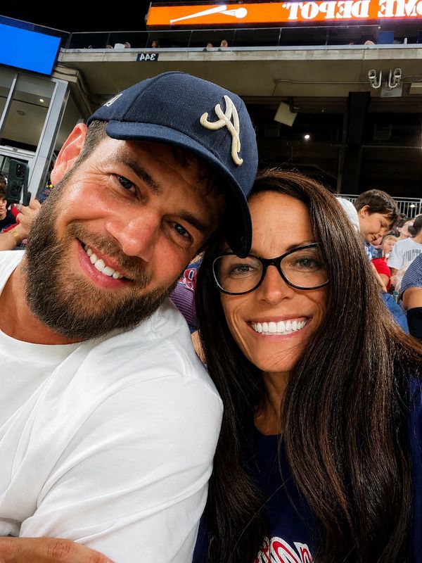 Smiling couple at a sporting event.