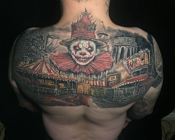 Large-scale creepy carnival backpiece packed with characters and architectural detail