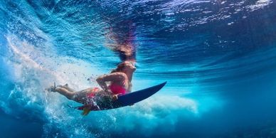 Dynamic wave ride on a vibrant teal surfboard