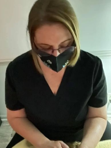 Person wearing a black mask and glasses.