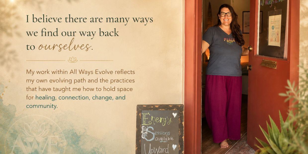 Woman stands smiling in a doorway next to a sign and motivational text.