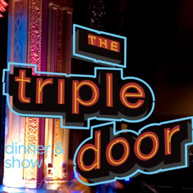 The Triple Door sign illuminated on a theater stage.
