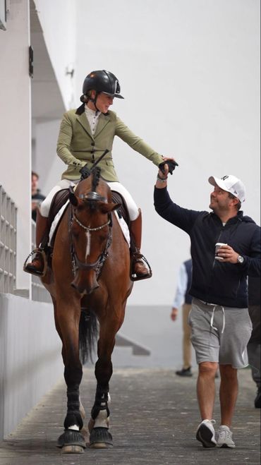 Alexandra and martin Williamson celebrating a great showjumping Round at SERC in UAE,