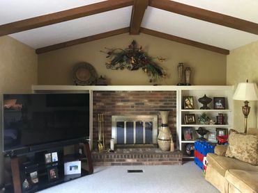Before: Dated living room with a traditional brick fireplace Needing refresh from ID Cincinnati.