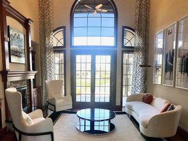 After: Spacious living room with large windows enhanced by a thoughtful design update.