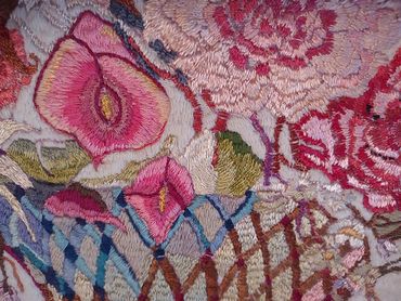Close up of embroidered basket of flowers by Inez Running-rabbit.
