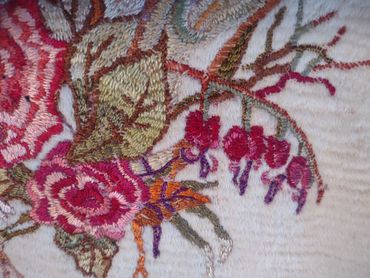 Close up of embroidered basket of flowers by Inez Running-rabbit.