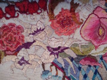 Close up of embroidered basket of flowers by Inez Running-rabbit.