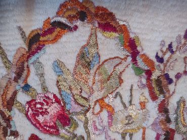Close up of embroidered basket of flowers by Inez Running-rabbit.