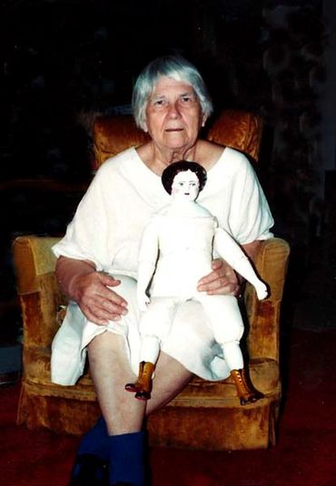 Inez Running-rabbit with the China doll that she made from scratch.
